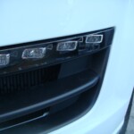 Before and after photographs of a damaged white, AUDI Quattro SUV that was repaired by Elite Paint & Body Shop in West Palm Beach, Florida.